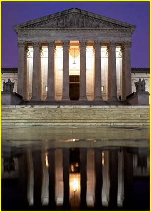 Supreme Court  building at night with reflection on pond